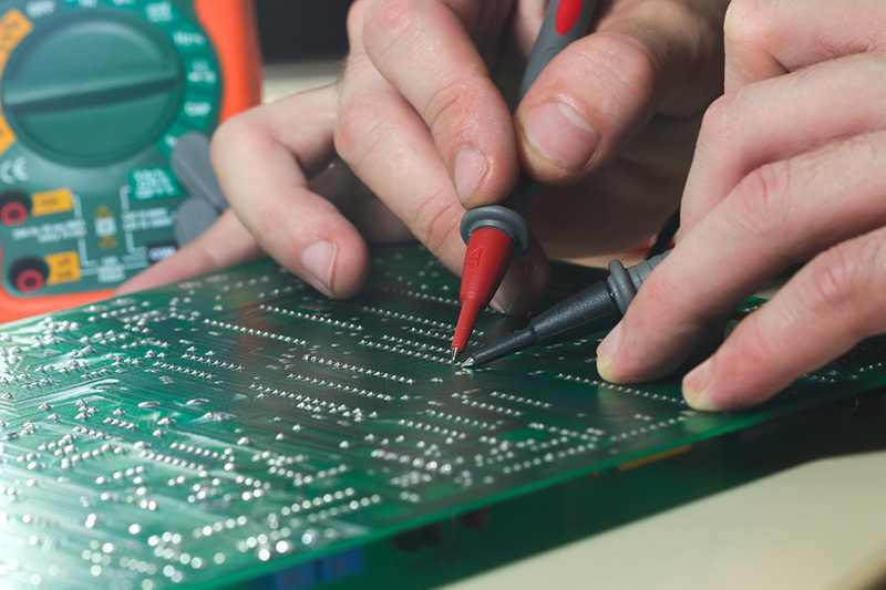 Engineer Is Testing Circuit Board With Instrument